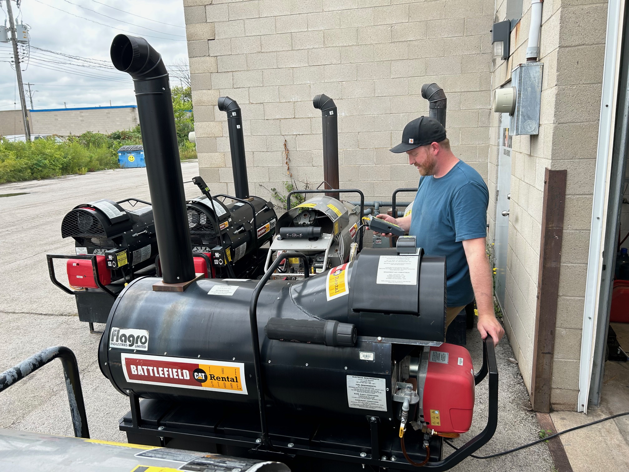 Professional Diagnostics Technician diagnosing a commercial heater using diagnostic tools in a service shop